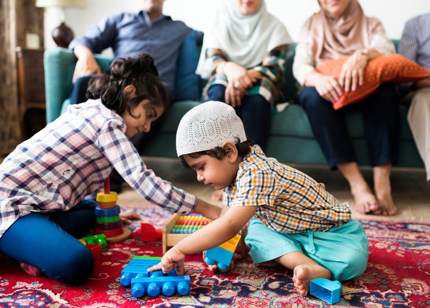Children at play while the family sits together behind them