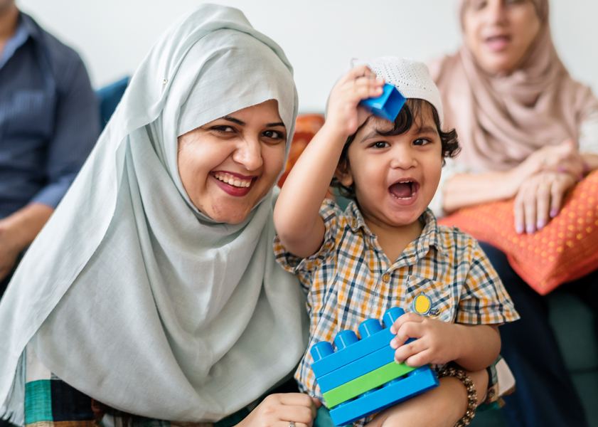 A mother laughing with her small son